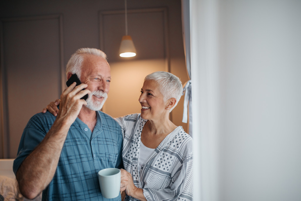 a senior man and woman talking on a phone