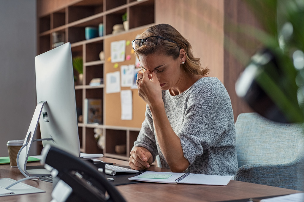 female employee stressed in office