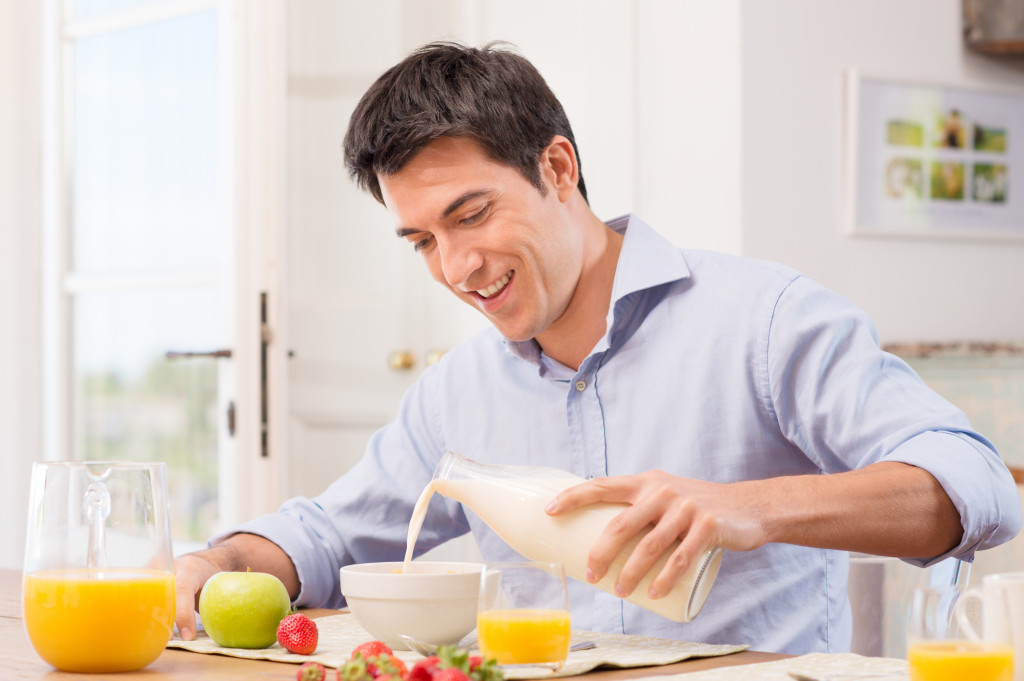 man eating fruits for breakfast with milk
